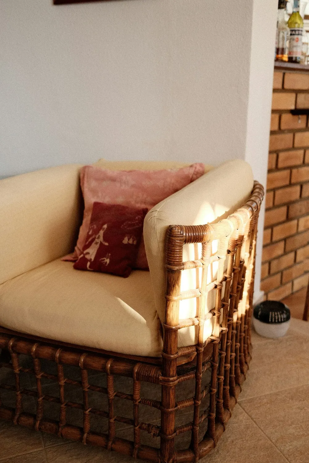 Wicker armchair with cushions in warm light